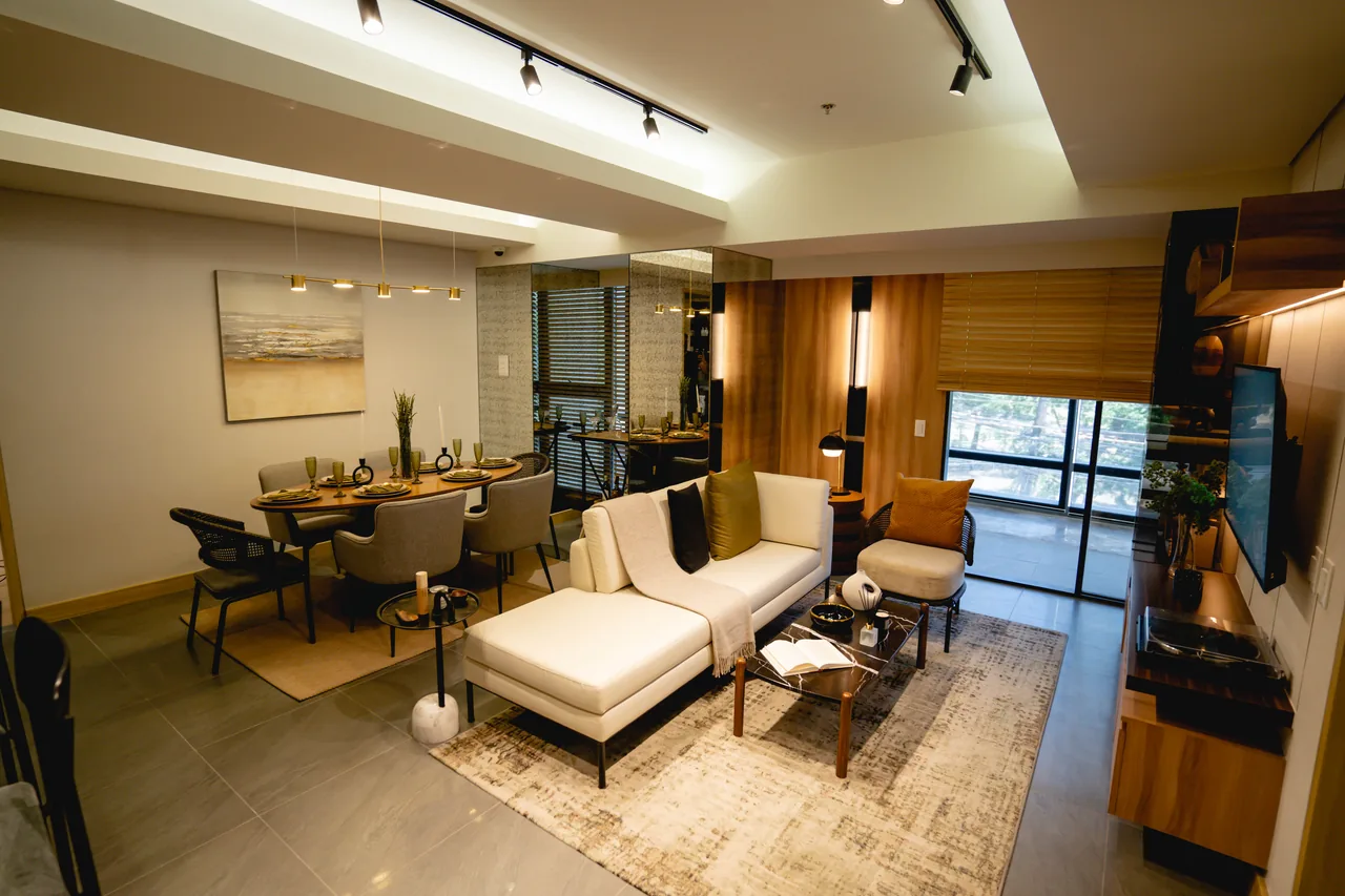 A bedroom at Lucima behind a glazed partition, seen from the living area.