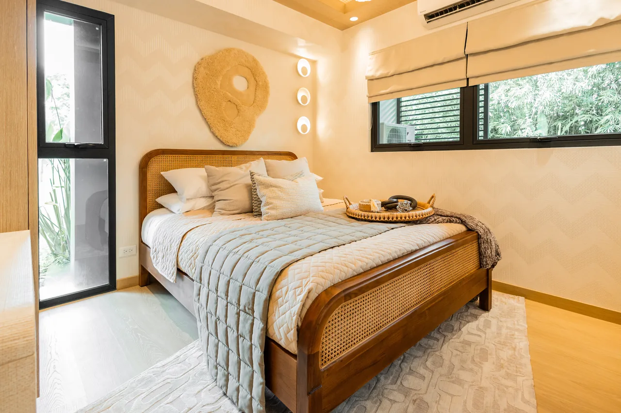 The bedroom of the Una Apartments one-bedroom model unit, styled for viewing.