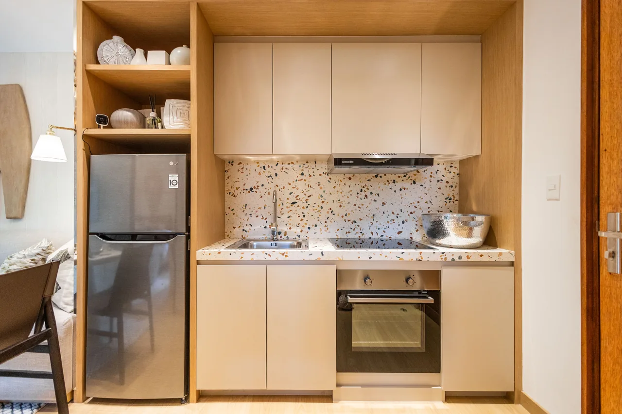 The kitchen run of a one-bedroom model unit at Una Apartments.